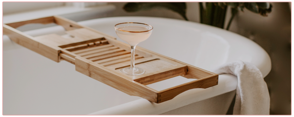 Glass of wine on bathtub tray