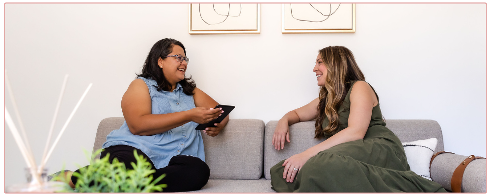 A coach and a client on the couch having a conversation together