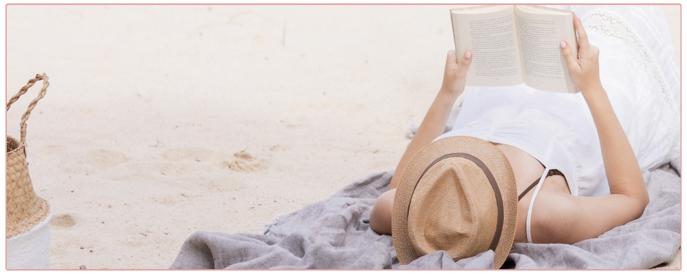 Woman working at her desk in her home office, looking at her phone